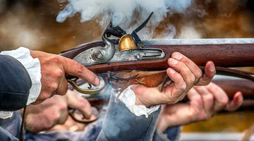 Man in revolutionary war attire firing a musket