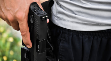 man holding pistol in holster