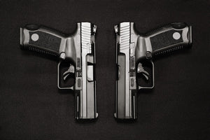 Two identical black pistols side-by-side.