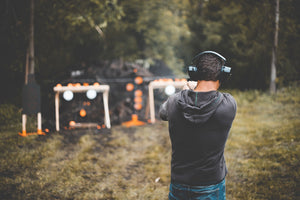 Man at range testing firearms.