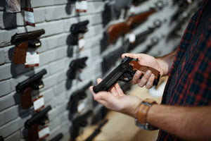 man shopping for handguns