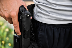man holding pistol in holster
